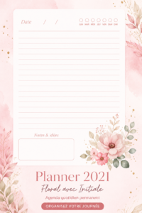Un planner floral ouvert sur une table, avec des stylos colorés à côté pour une organisation élégante.